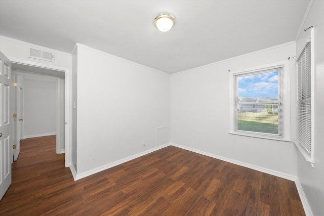 spare room with dark wood-type flooring and ornamental molding