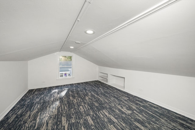 additional living space with lofted ceiling and hardwood / wood-style floors