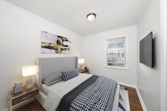 bedroom featuring crown molding and dark hardwood / wood-style flooring