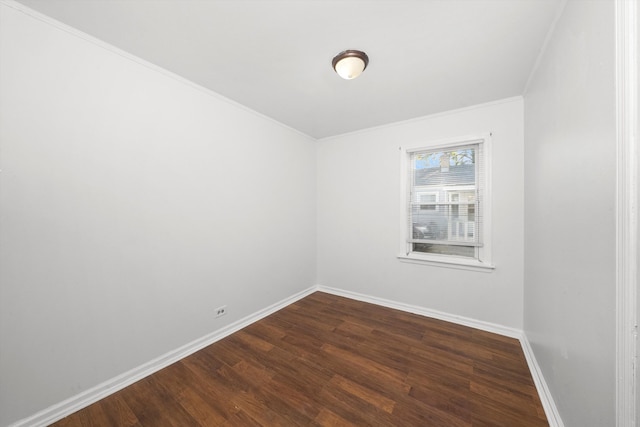 spare room featuring crown molding and hardwood / wood-style floors