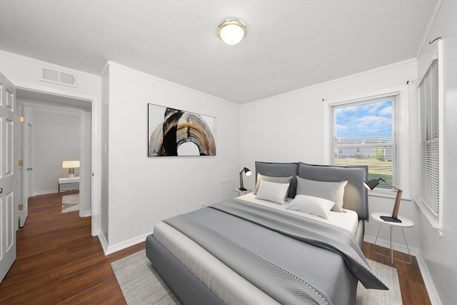 bedroom featuring ornamental molding and dark hardwood / wood-style flooring