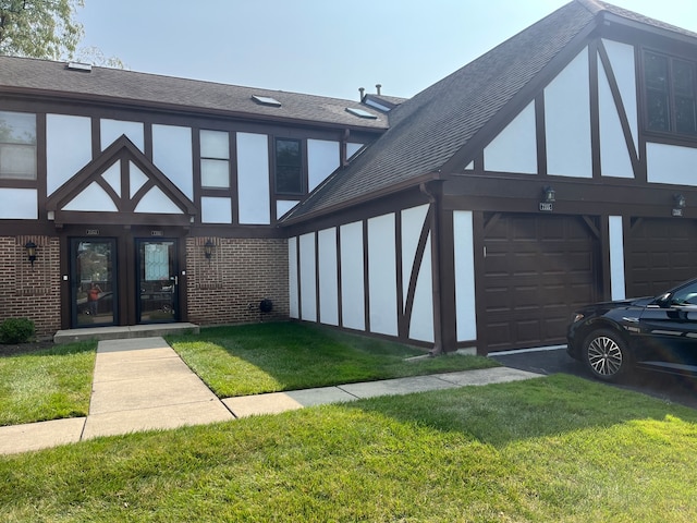 tudor-style house with a front yard and a garage