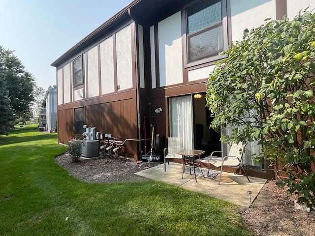 back of property featuring a yard and a patio