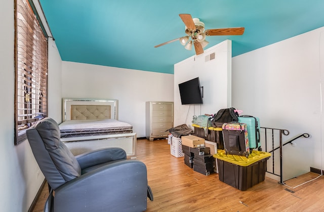 sitting room with ceiling fan and light wood-type flooring