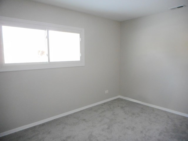 spare room featuring light colored carpet