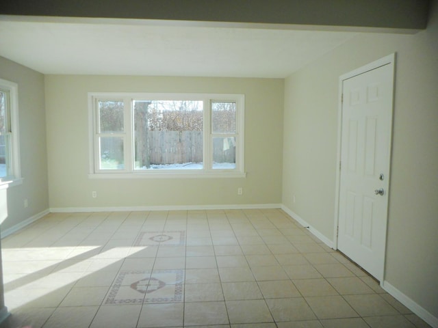 unfurnished room featuring light tile patterned flooring