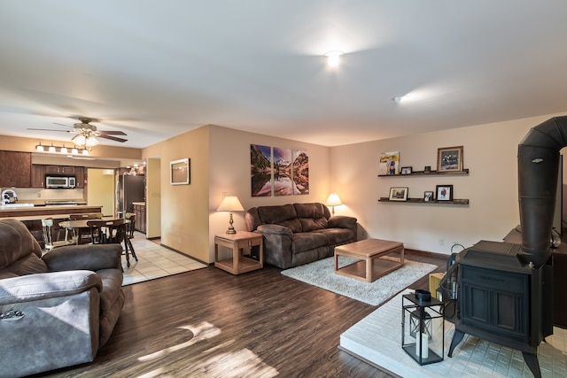 living room with light hardwood / wood-style flooring, ceiling fan, and sink