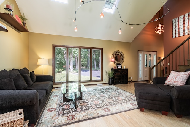 living room featuring hardwood / wood-style floors and high vaulted ceiling