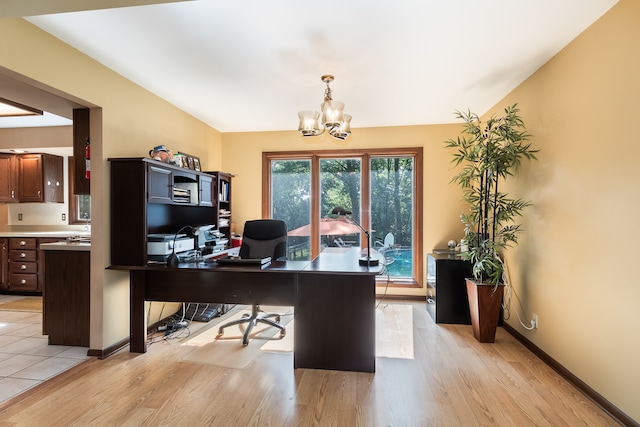 home office with a notable chandelier and light hardwood / wood-style floors