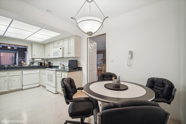 dining room featuring light wood-type flooring and sink