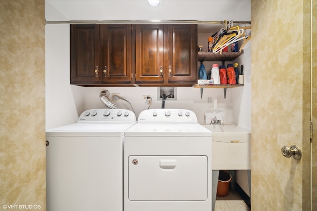 laundry area featuring sink, cabinets, and washing machine and dryer