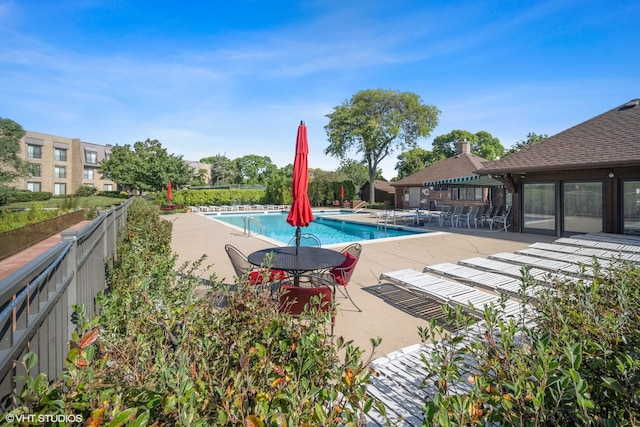 view of swimming pool with a patio