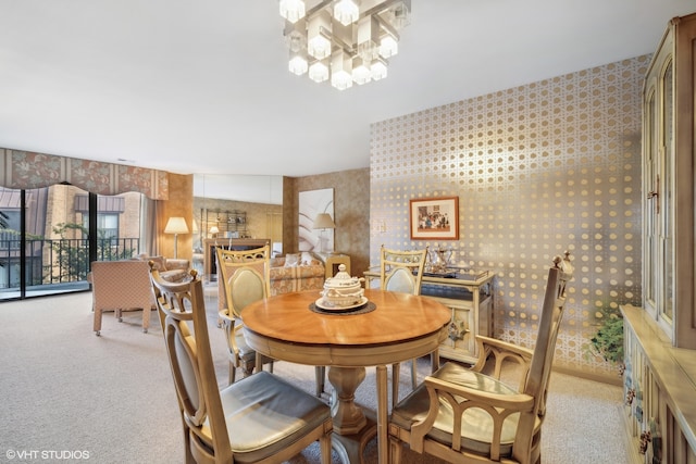 carpeted dining room with a chandelier