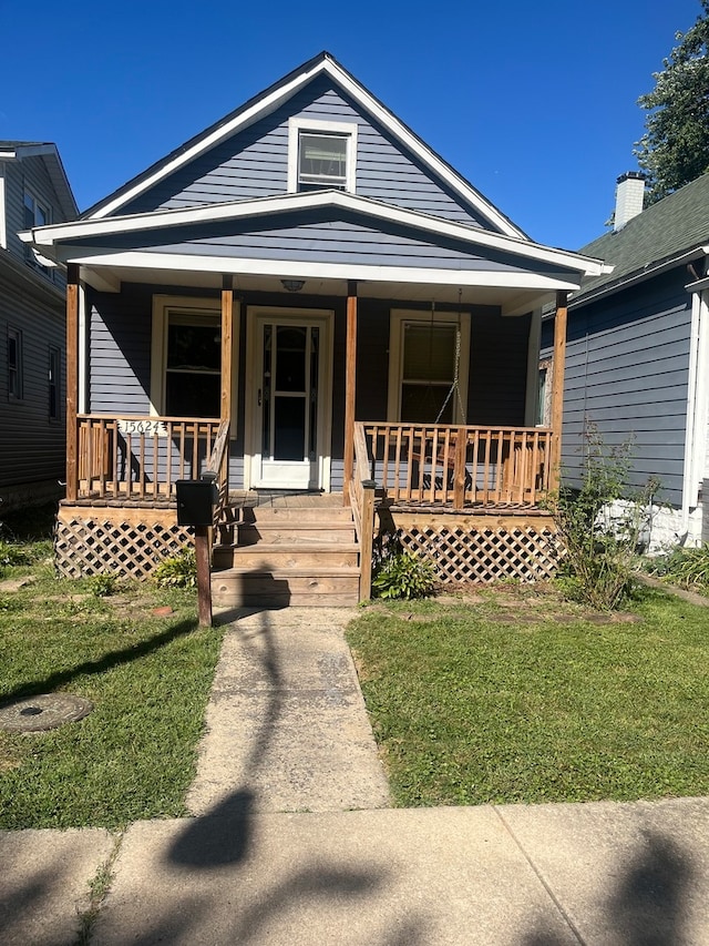 view of front of property with a front lawn and covered porch