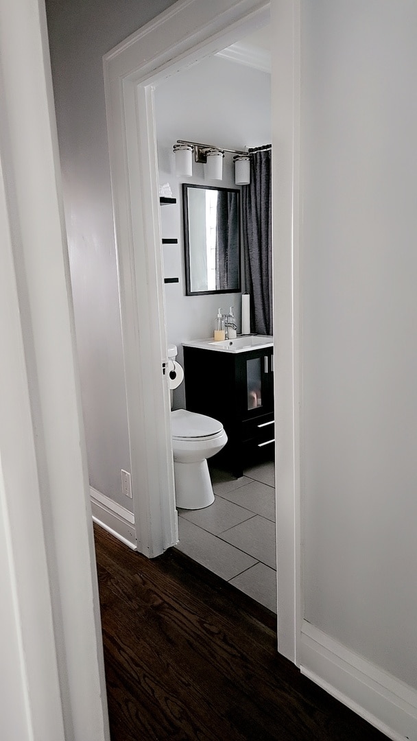 bathroom featuring vanity, hardwood / wood-style floors, and toilet