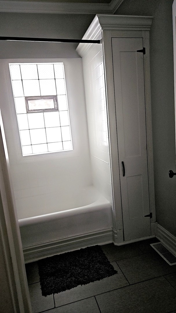 bathroom featuring bathing tub / shower combination and tile patterned floors