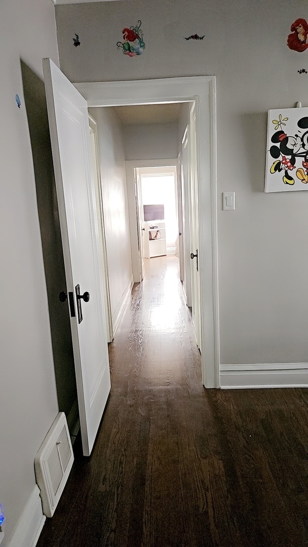 corridor featuring dark hardwood / wood-style floors and washer / dryer