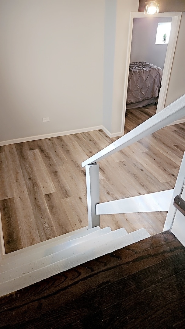 stairway featuring wood-type flooring