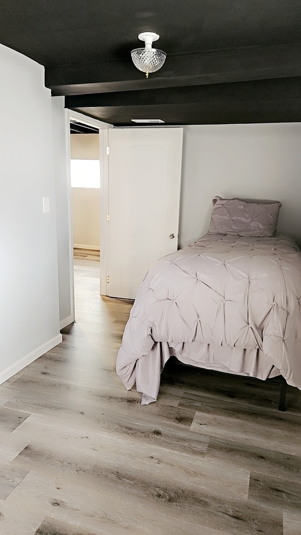 unfurnished bedroom with hardwood / wood-style floors