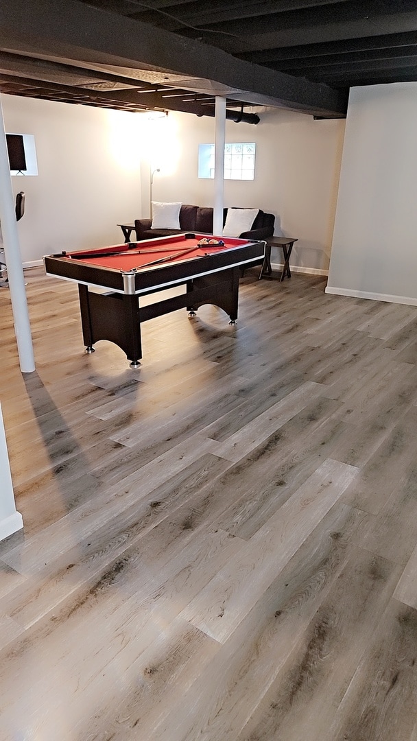 playroom featuring beamed ceiling and wood-type flooring