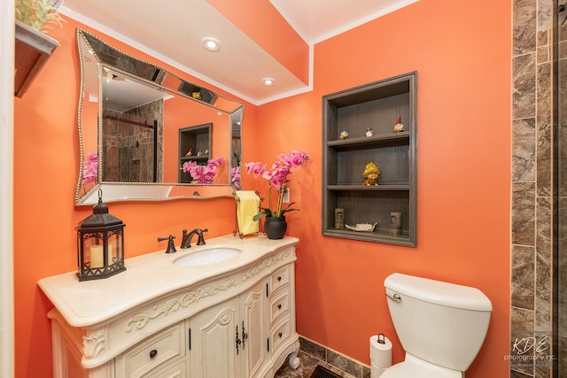 bathroom featuring walk in shower, crown molding, vanity, and toilet