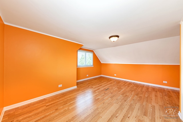 bonus room featuring vaulted ceiling and hardwood / wood-style floors