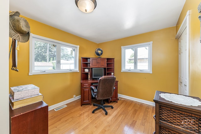 office space with light hardwood / wood-style flooring and a wealth of natural light