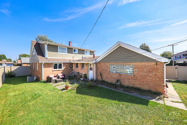 rear view of house with cooling unit, an outdoor hangout area, a lawn, and a patio area