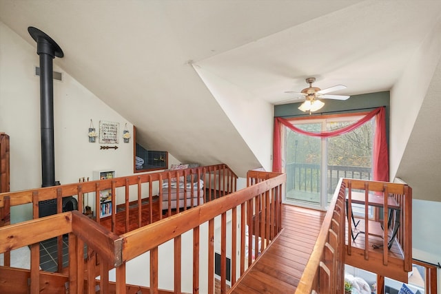 stairway with hardwood / wood-style floors, vaulted ceiling, and ceiling fan