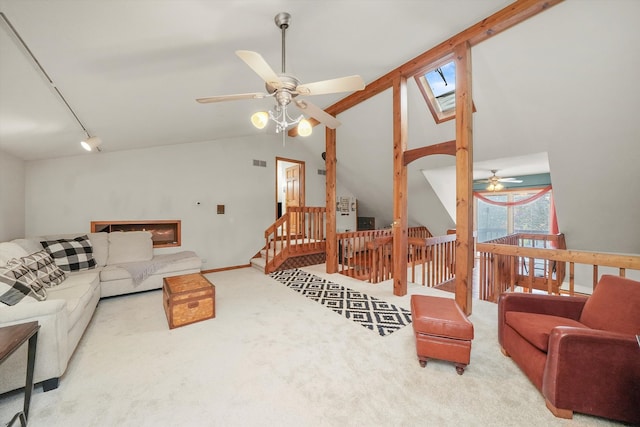 living room with carpet flooring, track lighting, high vaulted ceiling, and ceiling fan