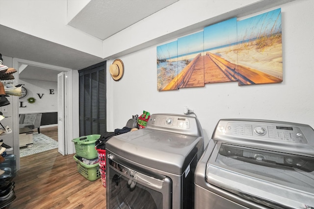 washroom featuring washing machine and dryer and hardwood / wood-style flooring