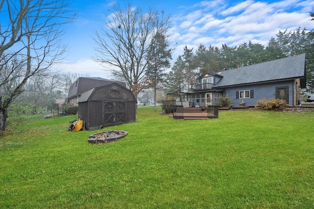 view of yard with a wooden deck and a shed