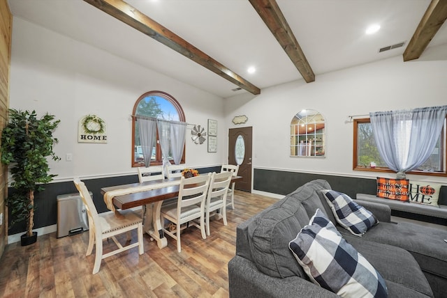 dining space featuring vaulted ceiling with beams and wood-type flooring