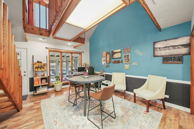 dining space with lofted ceiling and light hardwood / wood-style flooring