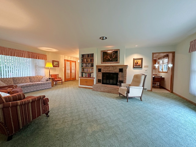 carpeted living room featuring built in shelves and a fireplace