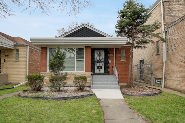 bungalow-style house featuring a front lawn