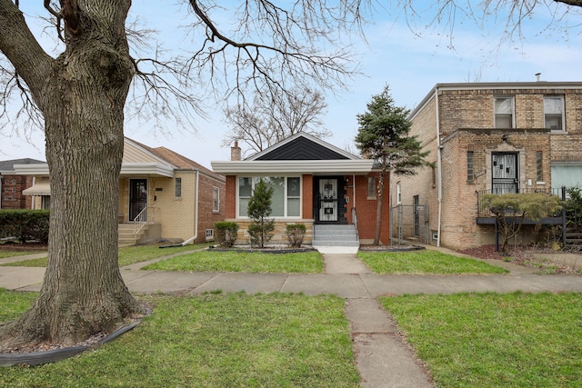 bungalow-style house featuring a front lawn