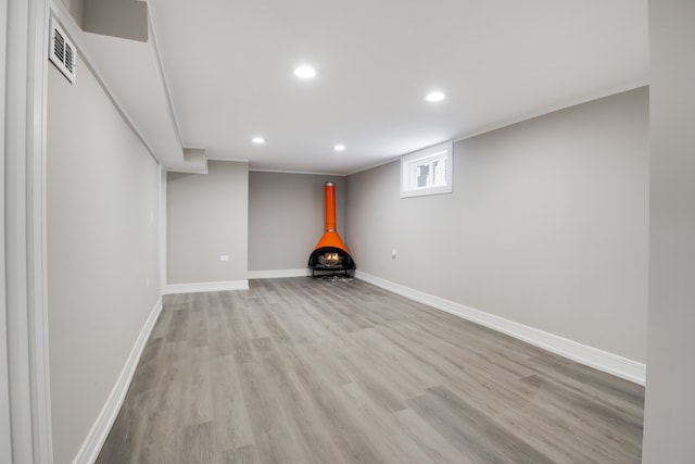 basement with light hardwood / wood-style floors