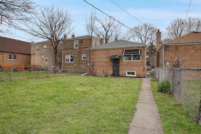 rear view of property with a yard