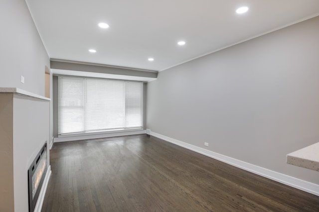 unfurnished room with dark wood-type flooring