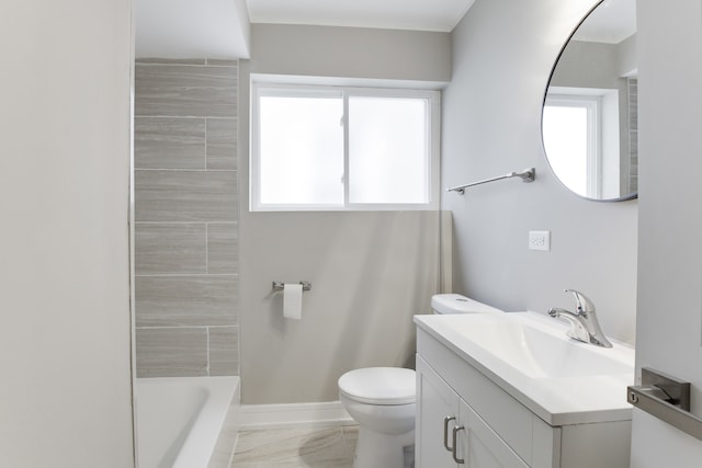 bathroom with a healthy amount of sunlight, toilet, and vanity