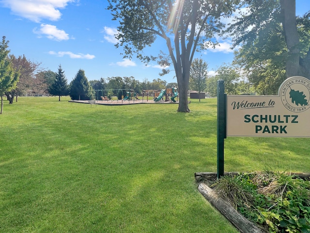 view of home's community with a yard and playground community