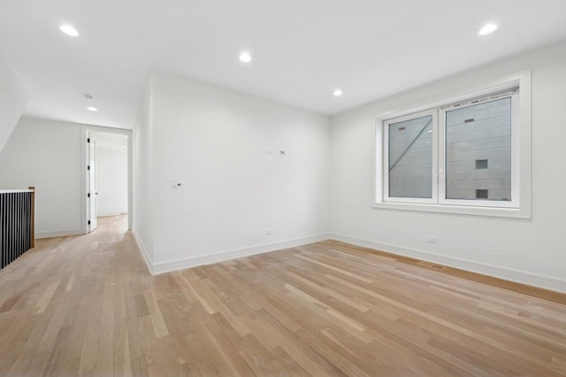 unfurnished room with light wood-type flooring