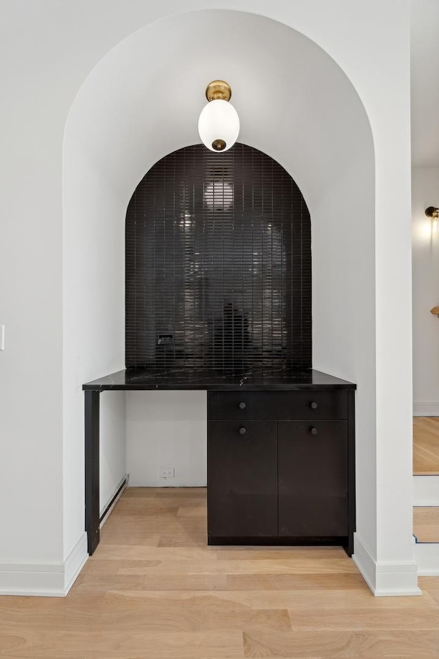 bar featuring light wood-type flooring