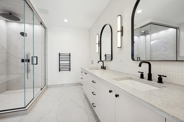 bathroom featuring vanity and an enclosed shower