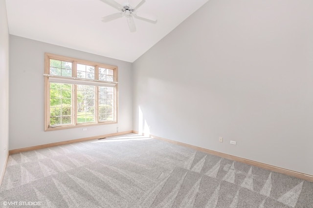 carpeted spare room with ceiling fan and high vaulted ceiling