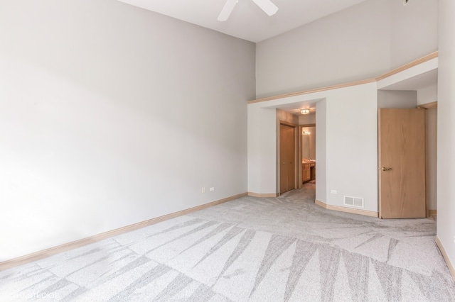 carpeted spare room featuring ceiling fan