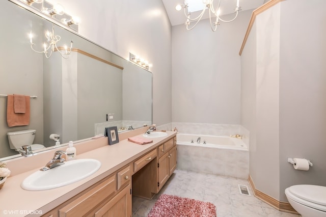 bathroom featuring toilet, a relaxing tiled tub, a chandelier, and vanity