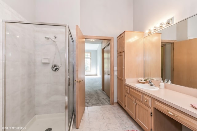 bathroom featuring vanity and an enclosed shower