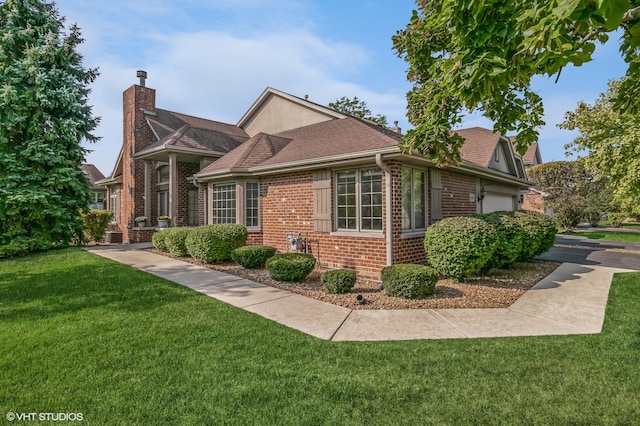 view of front of home with a front yard and a garage